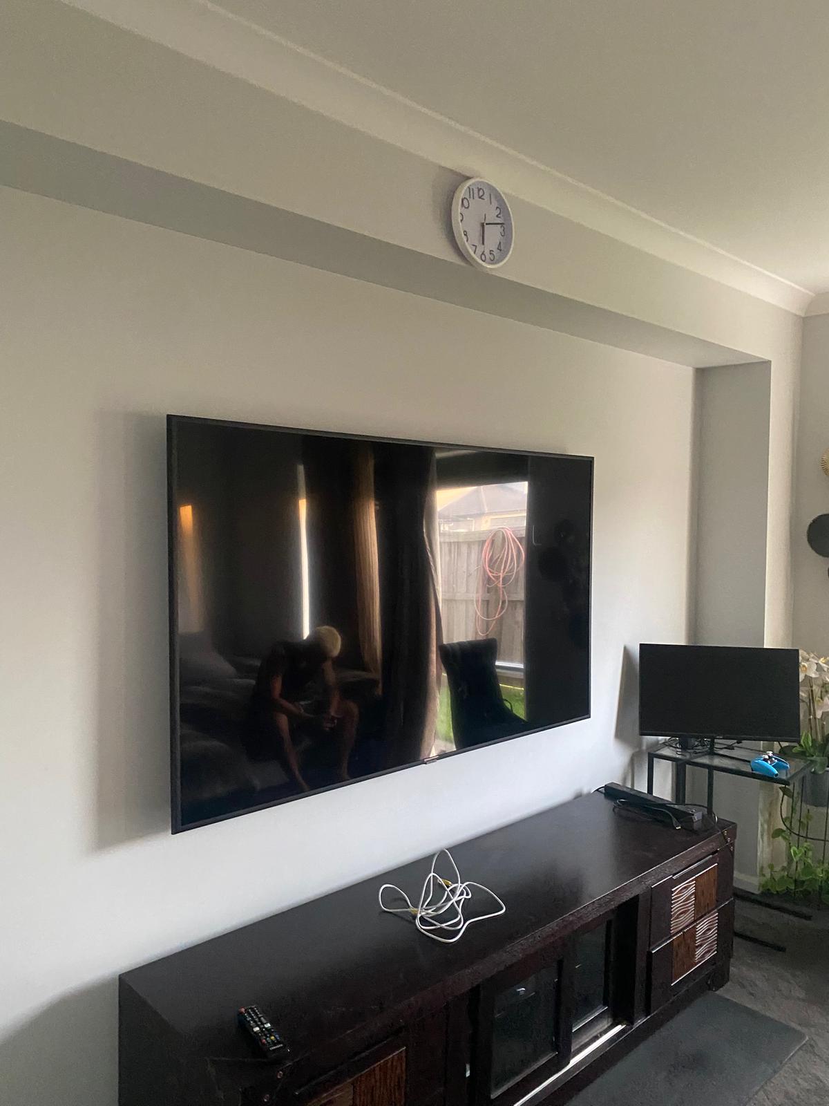 Large screen TV mounted in living room in Northgate