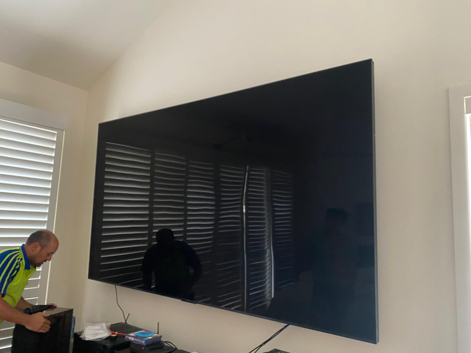Brisbane TVs technician installing large screen