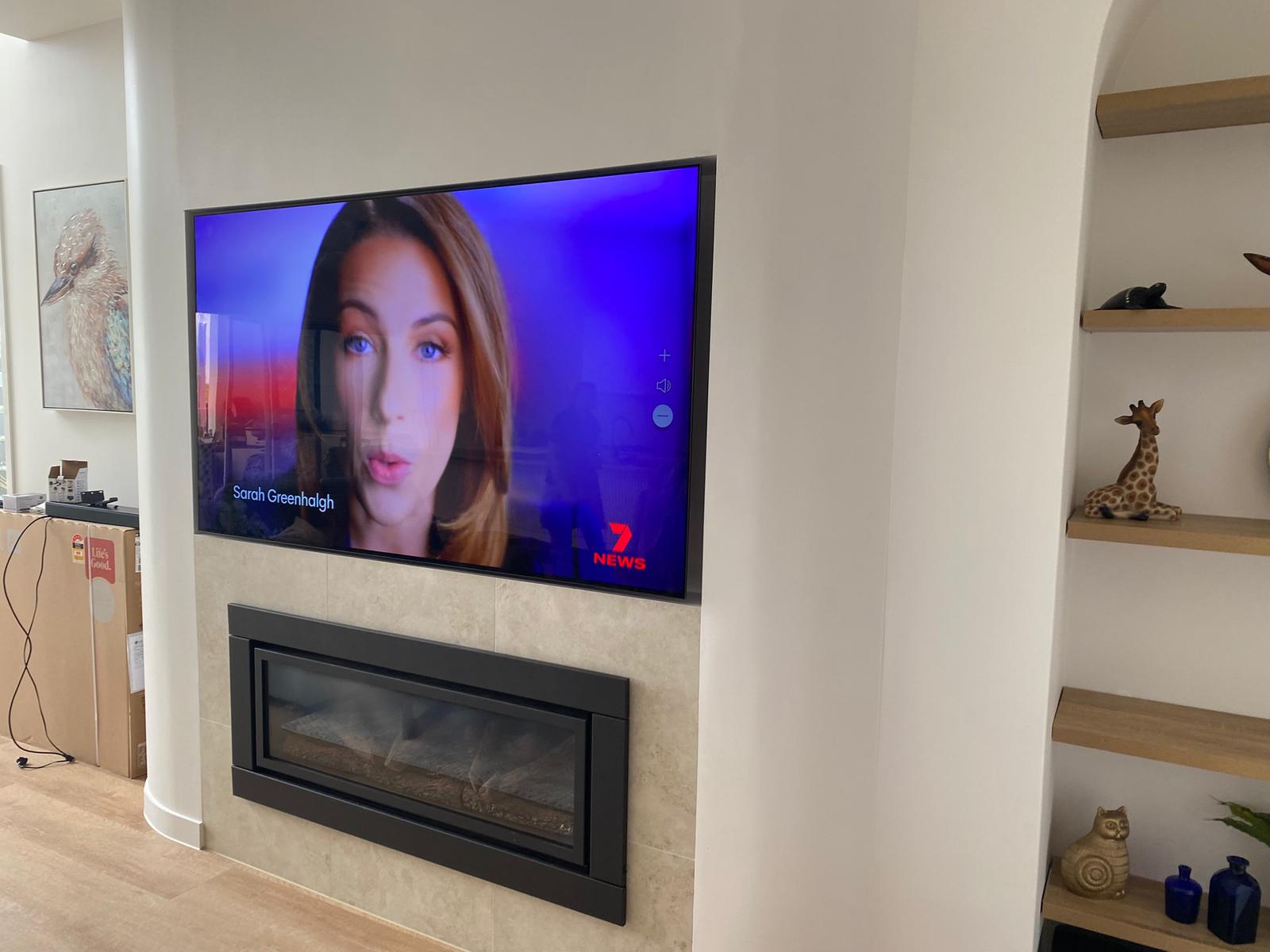 TV mounted above fireplace with hidden cables
